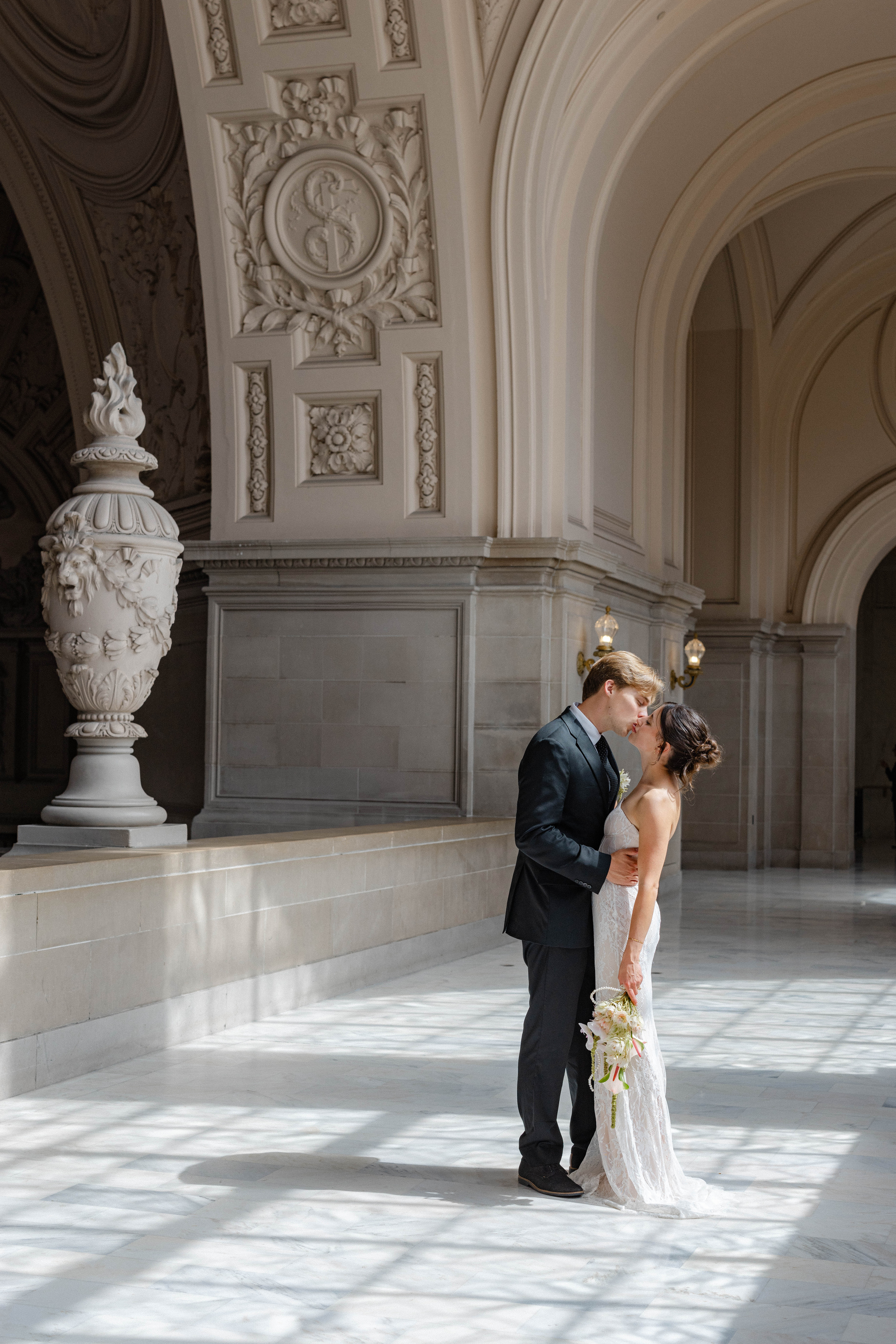 Groom kissing the bride on Mayor's Balcony